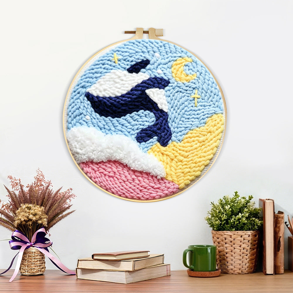 Finished orca and moon artwork displayed on a wall