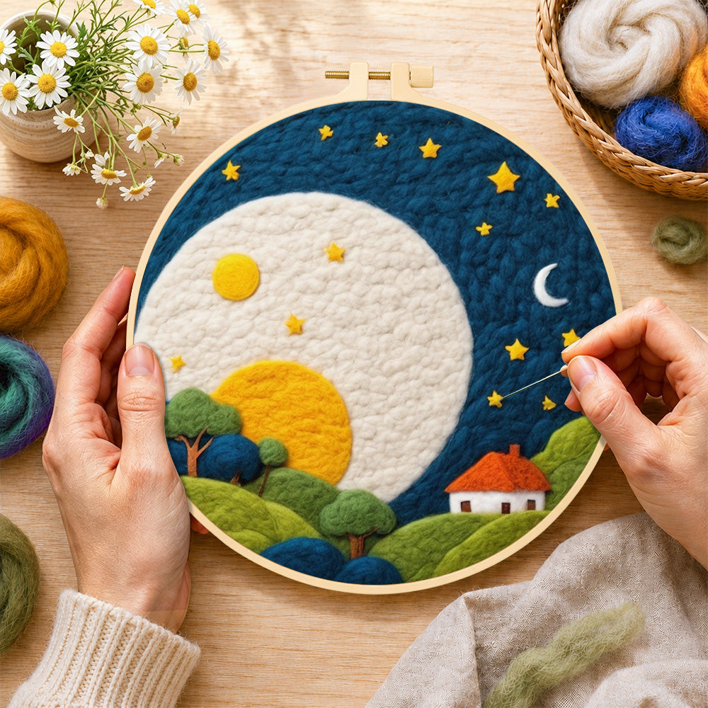 Creating the oversized moon over red-roof cottage wool painting by hand with a felting needle