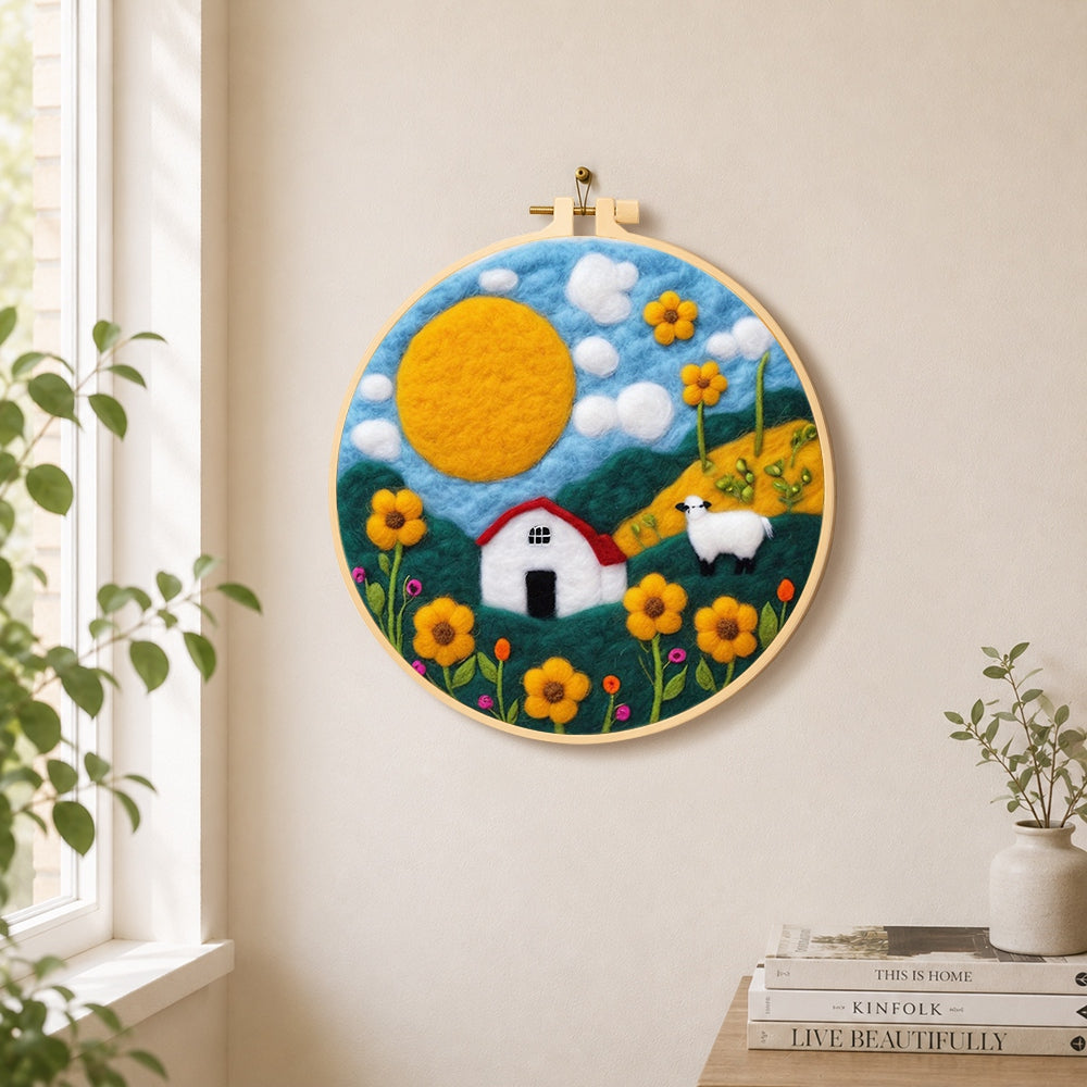 Oversized sun and sheep meadow needle felt wall art displayed in a bright home interior