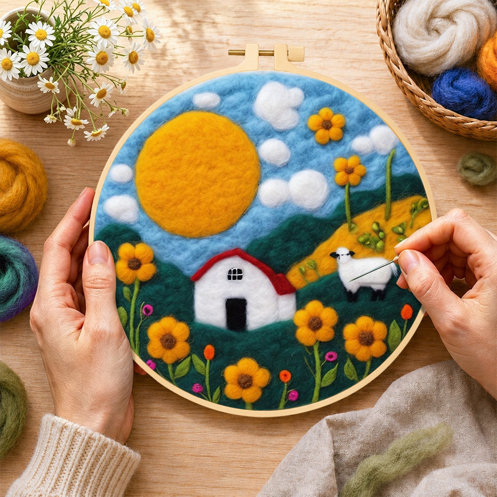 Creating the oversized sun and sheep meadow wool painting by hand with a felting needle