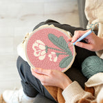 Creating handmade pale pink background with white flowers punch needle artwork