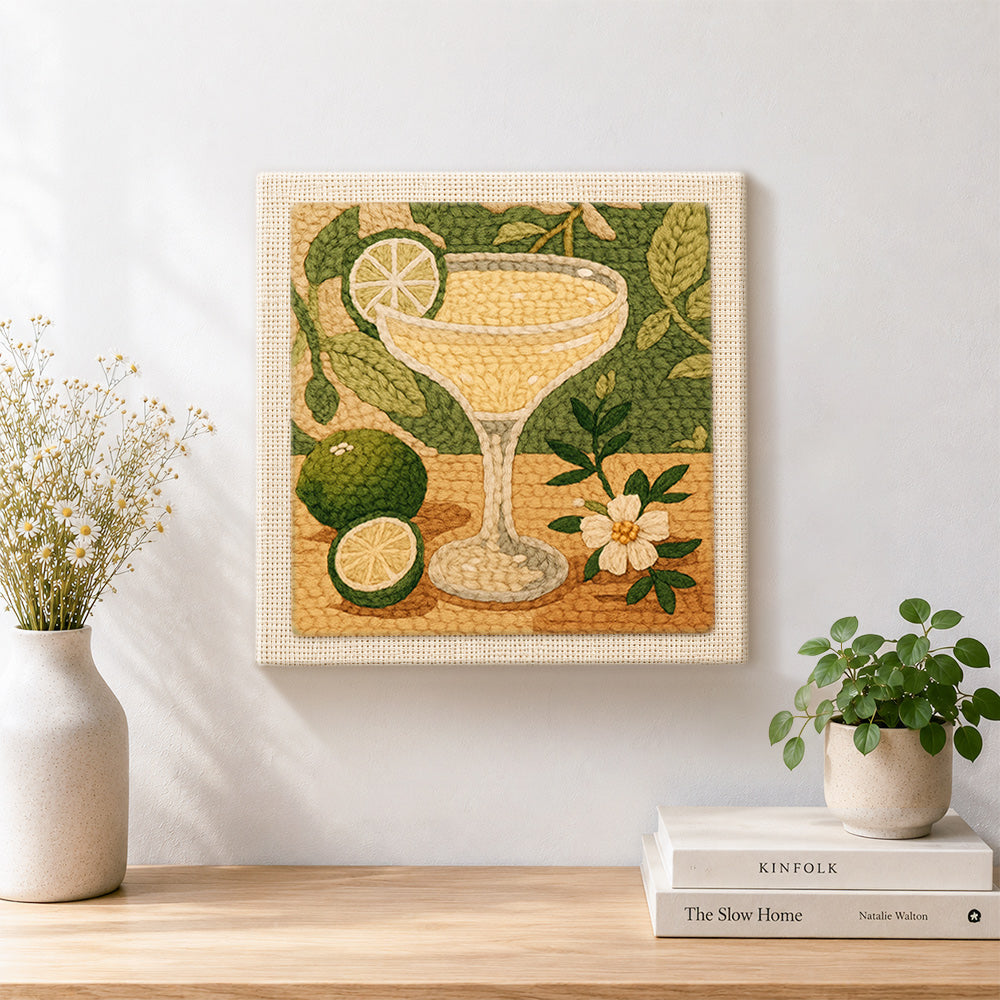 Finished pale yellow cocktail with lime artwork displayed on a wall