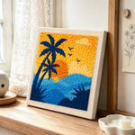 Palm tree and ocean punch needle artwork displayed on a table
