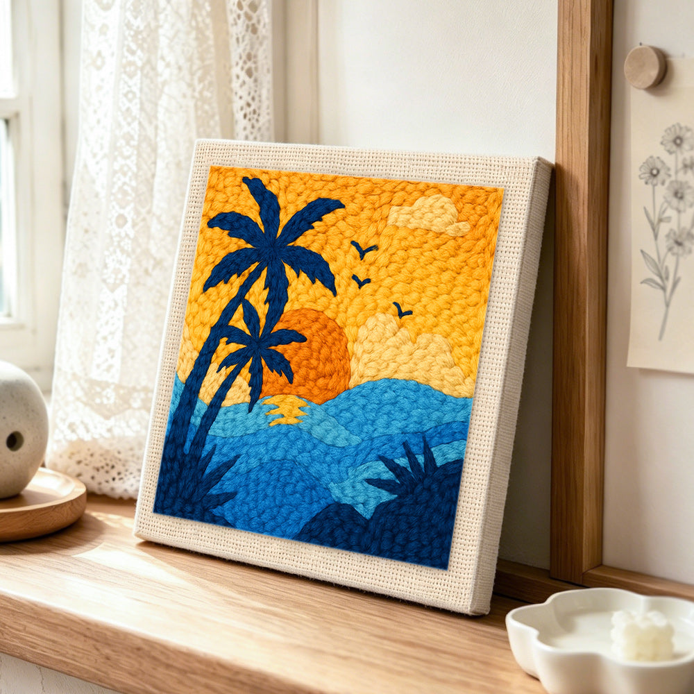 Palm tree and ocean punch needle artwork displayed on a table