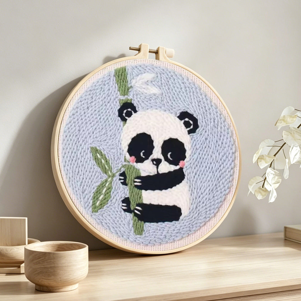Panda and bamboo punch needle artwork displayed on a table