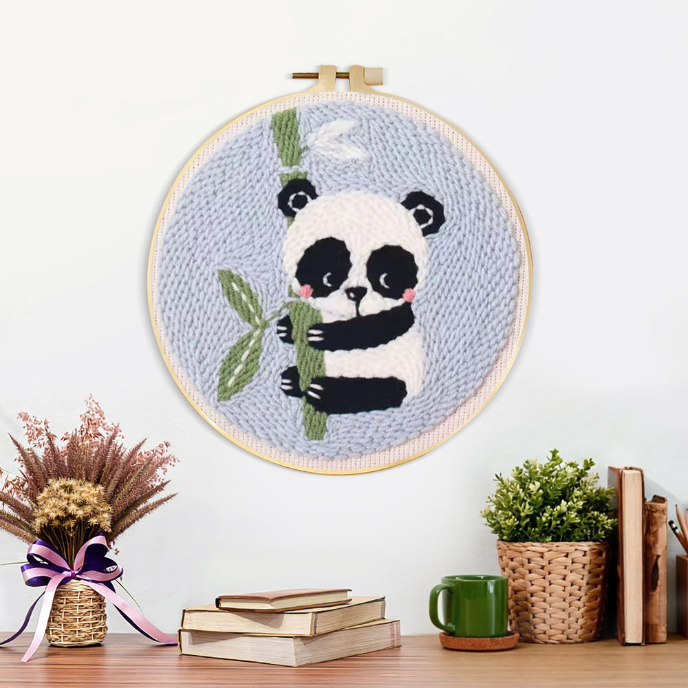 Finished panda and bamboo artwork displayed on a wall
