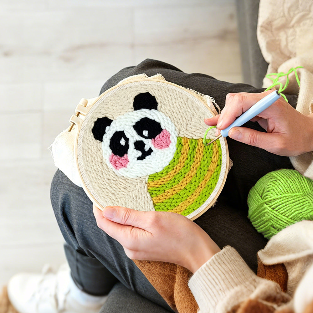 Creating handmade panda in green striped sweater punch needle artwork