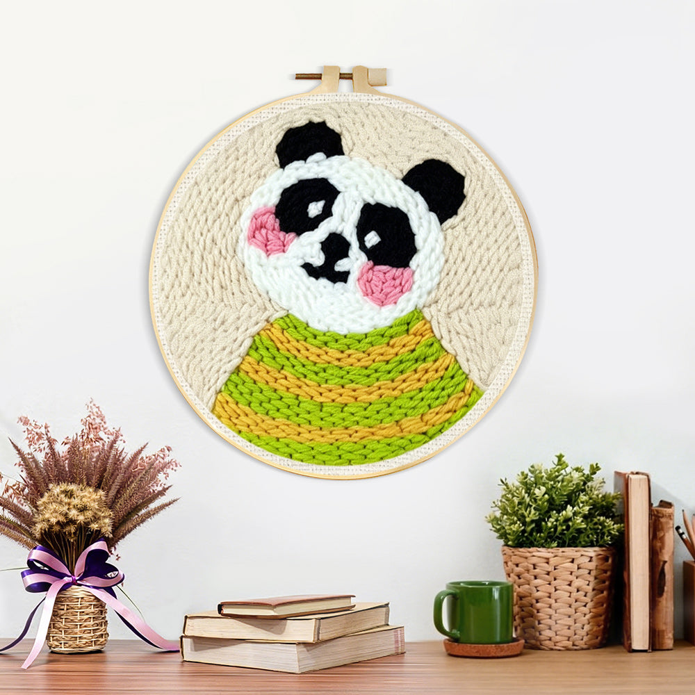 Finished panda in green striped sweater artwork displayed on a wall