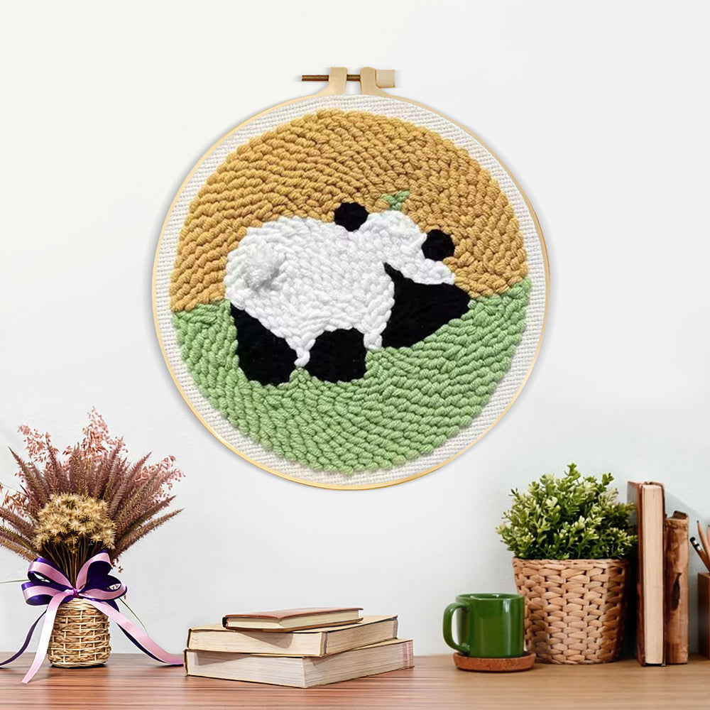 Finished panda in the meadow artwork displayed on a wall