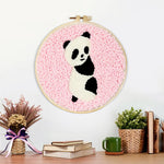 Finished panda on pink background artwork displayed on a wall