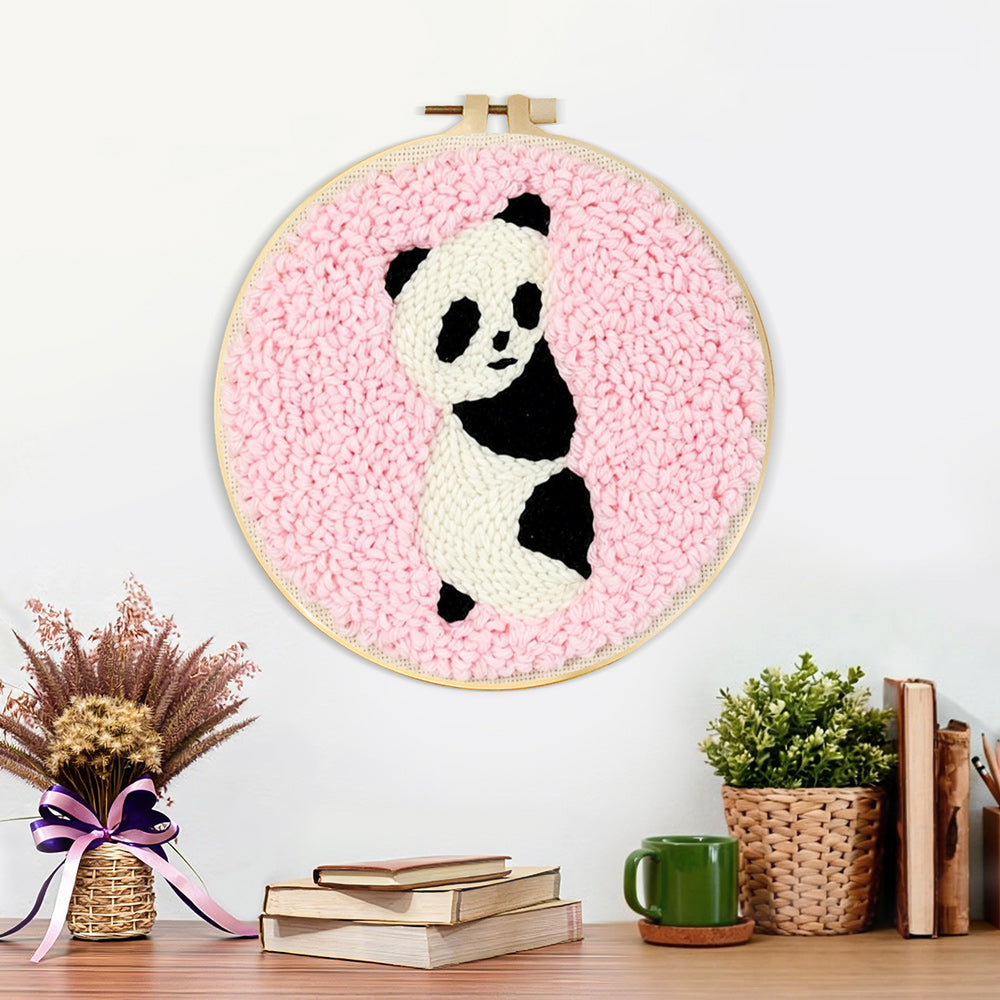 Finished panda on pink background artwork displayed on a wall