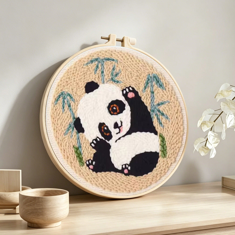 Panda stretching punch needle artwork displayed on a table