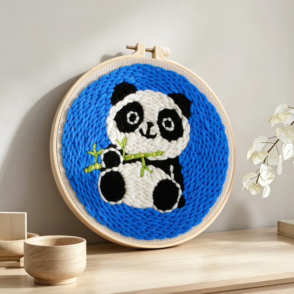 Panda with bamboo punch needle artwork displayed on a table