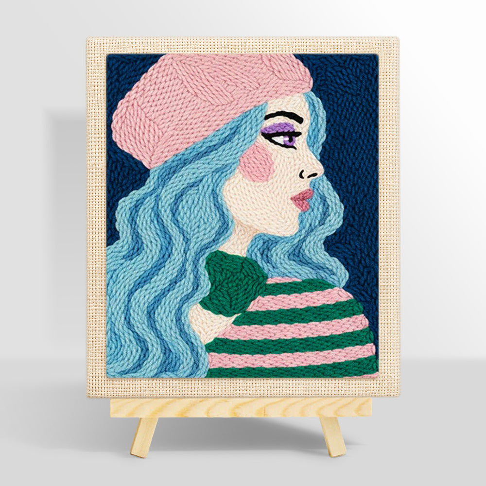 Pastel blue haired woman in pink beret punch needle kit for beginners