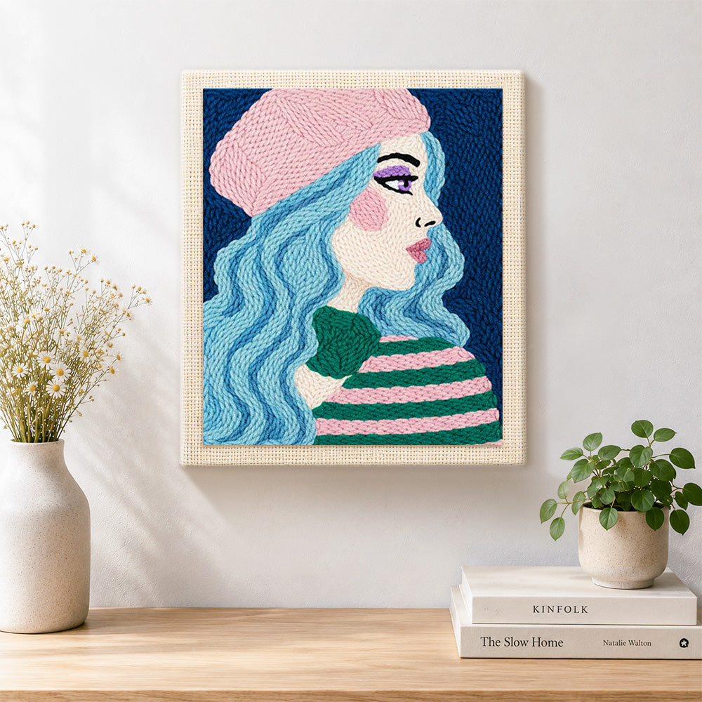 Finished pastel blue haired woman in pink beret artwork displayed on a wall