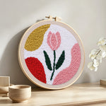 Pastel pink tulip punch needle artwork displayed on a table