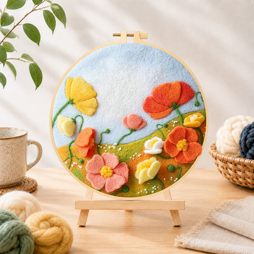 Finished pastel wildflower meadow needle felting displayed on a wooden easel