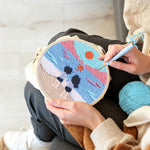 Creating handmade peaceful beach view with couple punch needle artwork