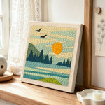 Peaceful lakeside morning punch needle artwork displayed on a table