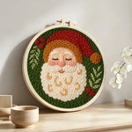 Peaceful santa claus portrait punch needle artwork displayed on a table
