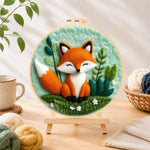 Finished peaceful sleeping fox needle felting displayed on a wooden easel