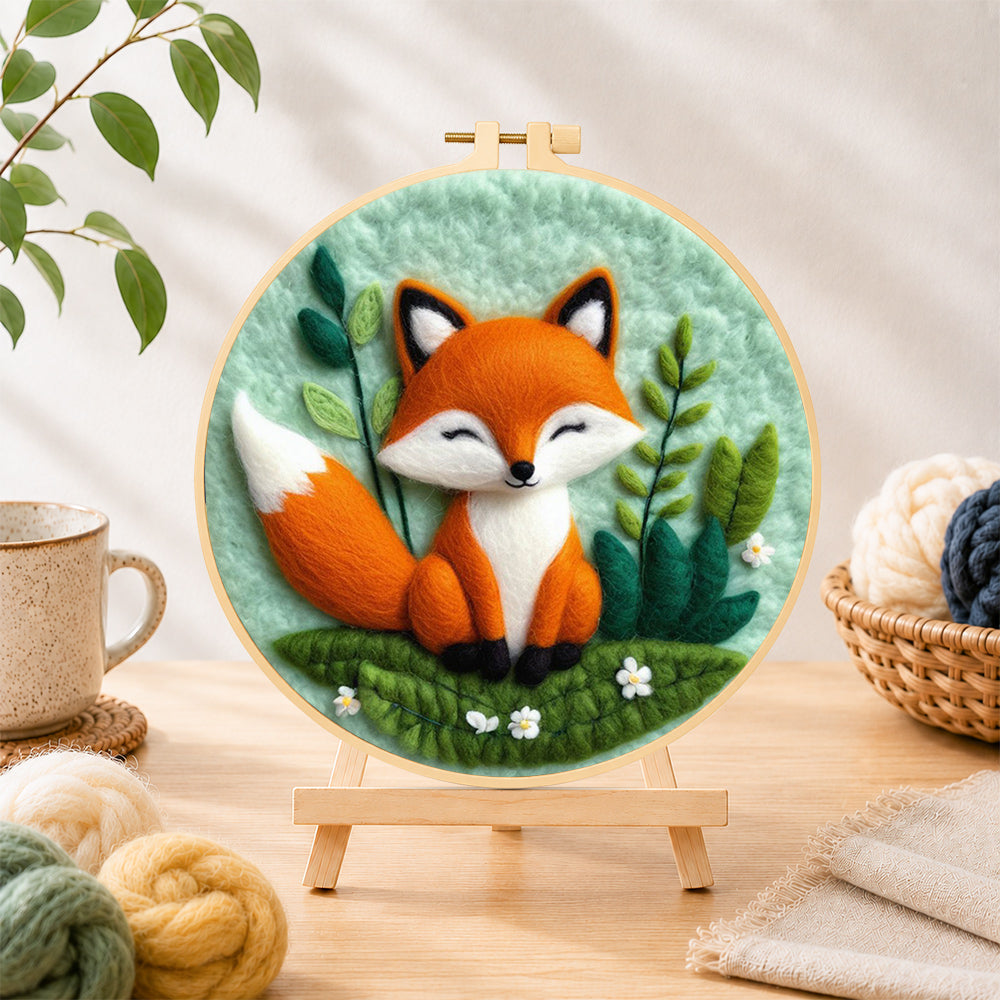 Finished peaceful sleeping fox needle felting displayed on a wooden easel