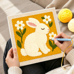 Creating handmade peaceful white bunny with daisies punch needle artwork