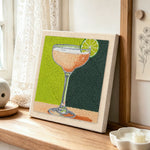 Peach drink with lime garnish punch needle artwork displayed on a table