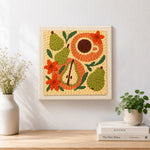 Finished pear, coffee and flowers artwork displayed on a wall