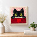 Finished peeking black cat with green eyes artwork displayed on a wall