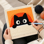 Creating handmade peeking black cat with orange arch background punch needle artwork