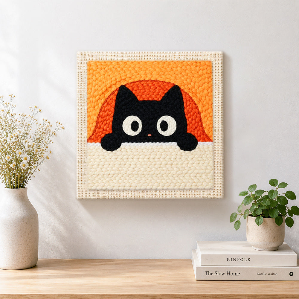 Finished peeking black cat with orange arch background artwork displayed on a wall