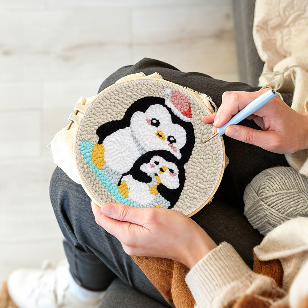 Creating handmade penguin with christmas hat punch needle artwork
