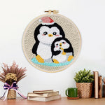 Finished penguin with christmas hat artwork displayed on a wall