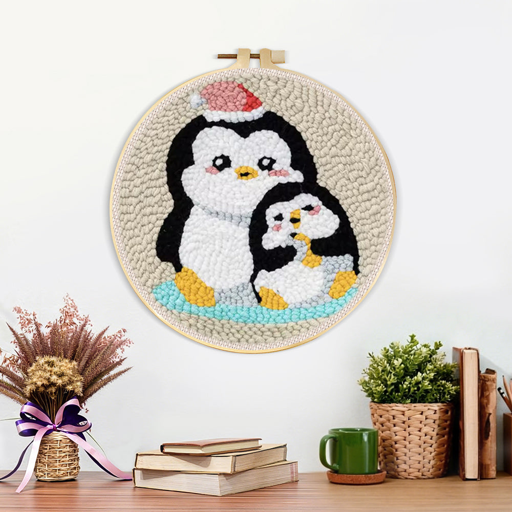 Finished penguin with christmas hat artwork displayed on a wall