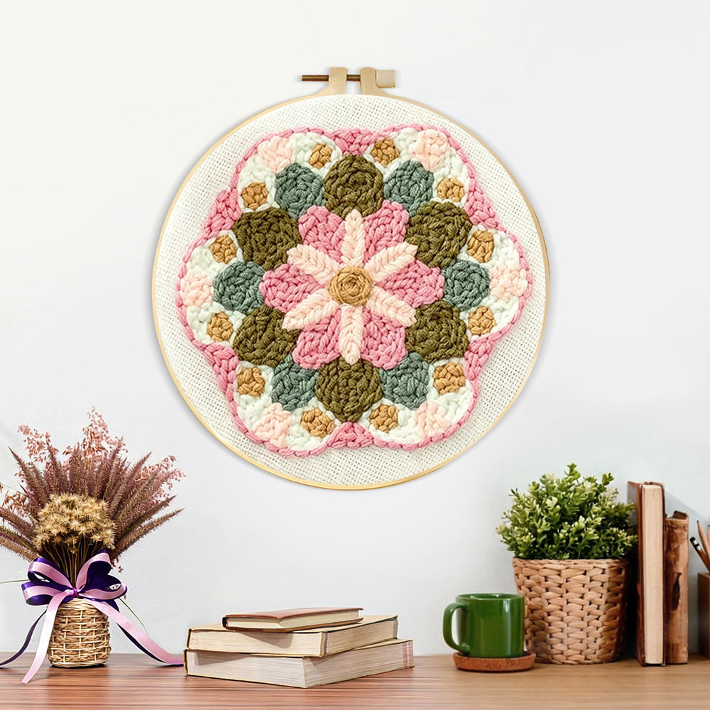 Finished pink and green flower mandala artwork displayed on a wall