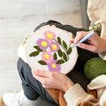 Creating handmade pink and purple bloom cluster punch needle artwork