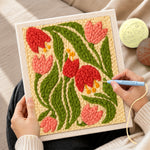 Creating handmade pink and red bell flowers punch needle artwork