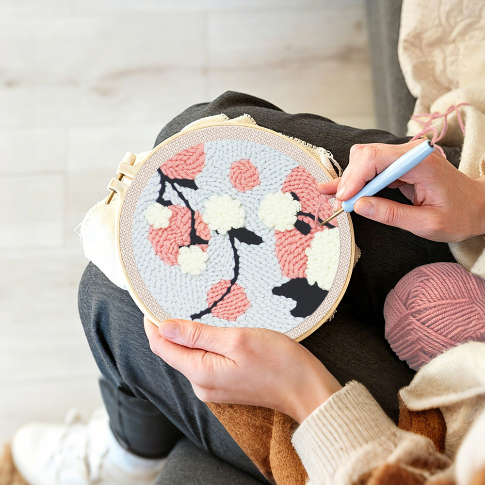 Creating handmade pink and white blossoms punch needle artwork