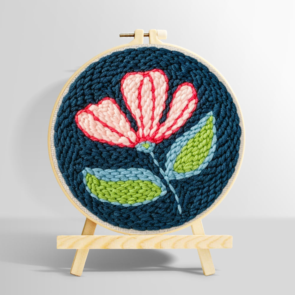 Pink and white flower on navy blue punch needle kit for beginners