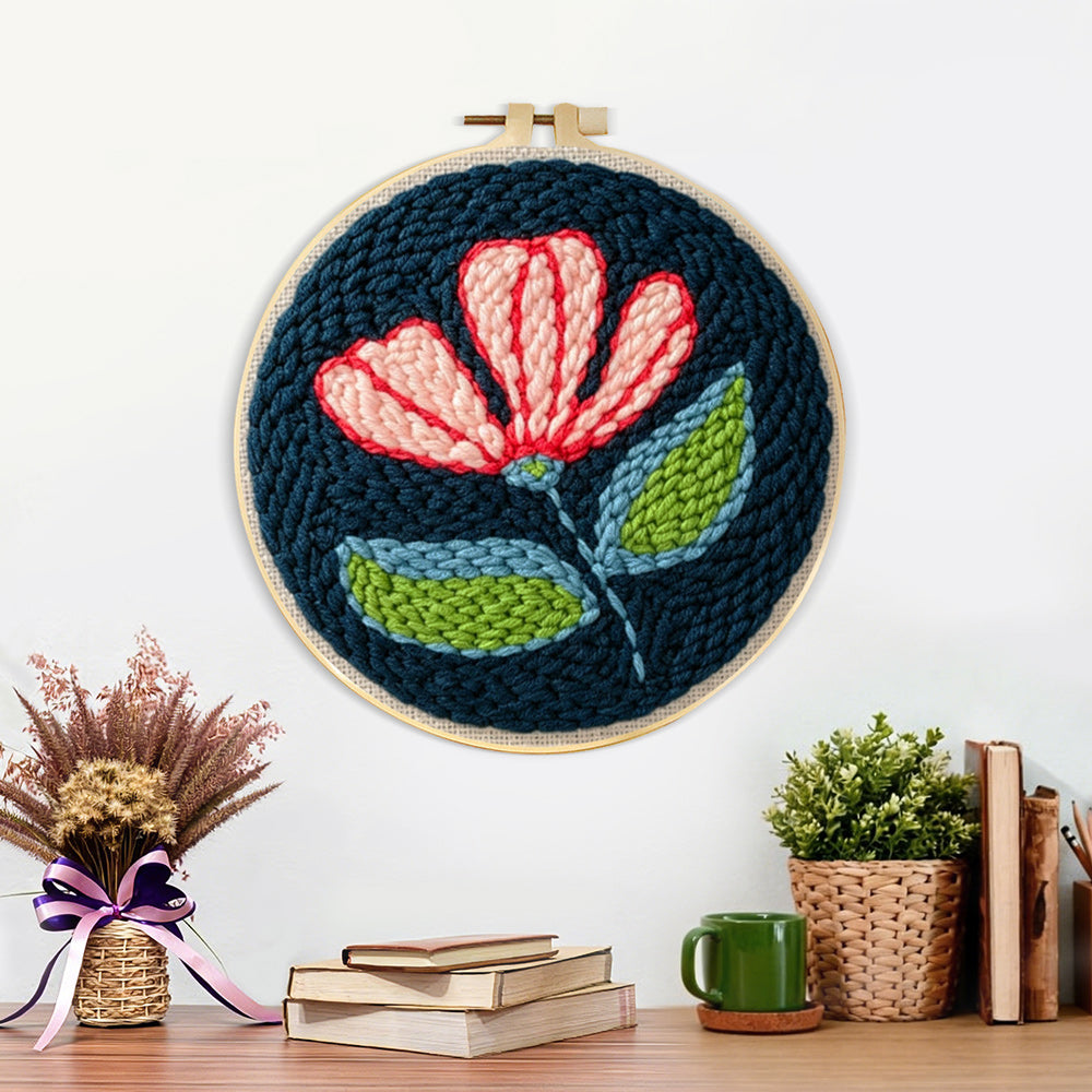 Finished pink and white flower on navy blue artwork displayed on a wall