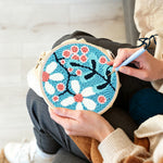 Creating handmade pink and white sakura punch needle artwork
