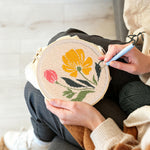 Creating handmade pink and yellow wildflowers punch needle artwork