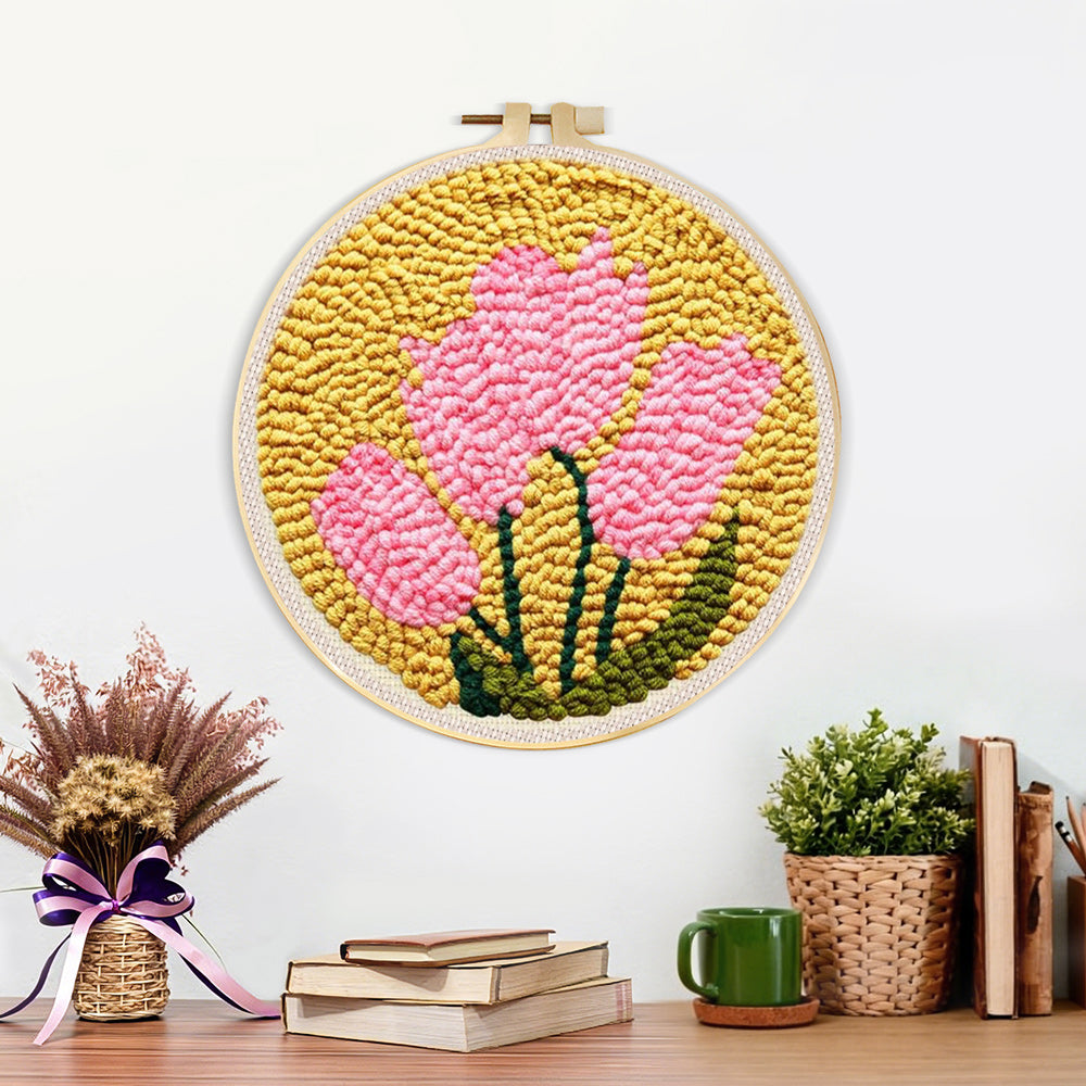 Finished pink blooms on mustard yellow background artwork displayed on a wall