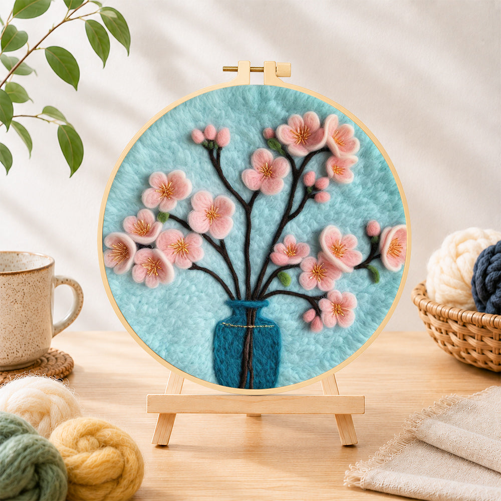 Finished pink blossom in blue vase needle felting displayed on a wooden easel
