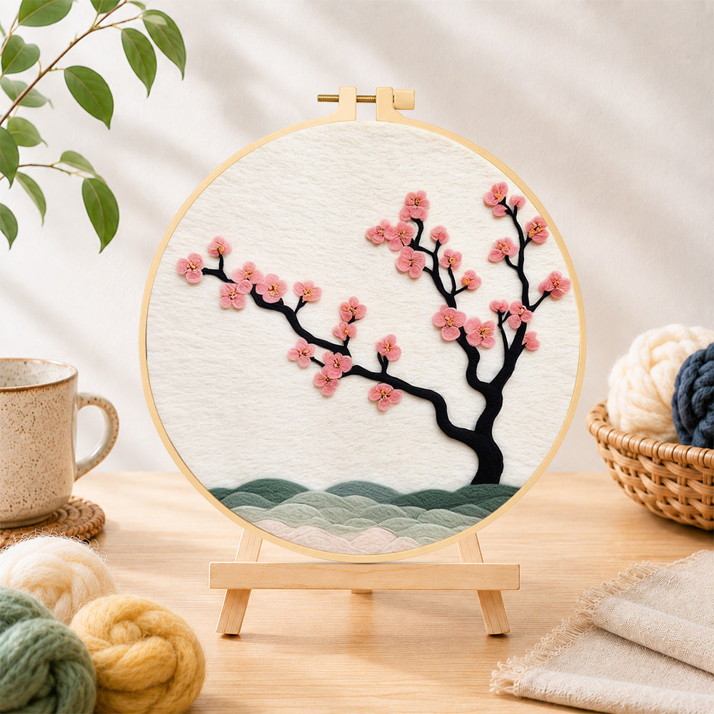 Finished pink blossom on black branch needle felting displayed on a wooden easel