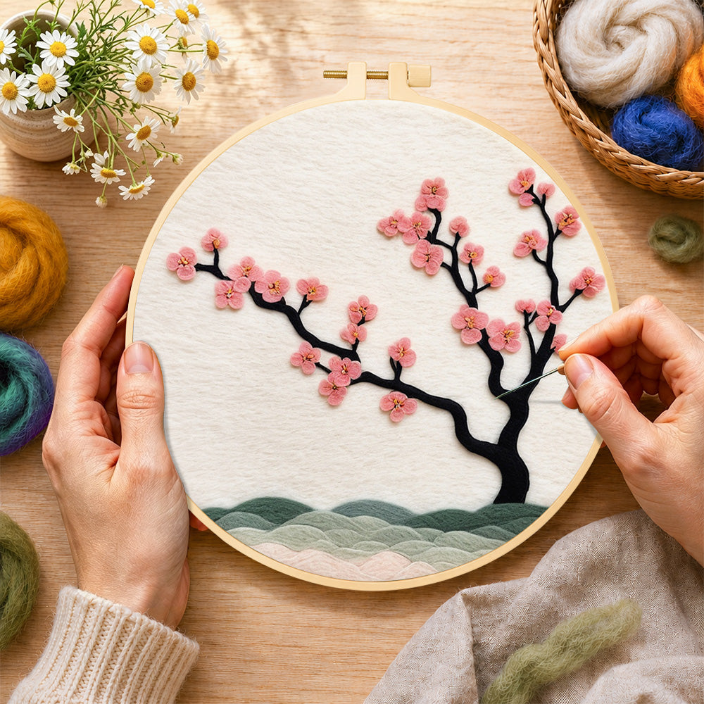 Creating the pink blossom on black branch wool painting by hand with a felting needle