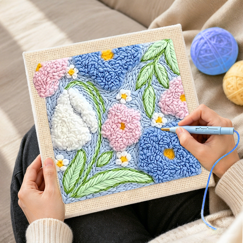 Creating handmade pink, blue and white blossoms punch needle artwork