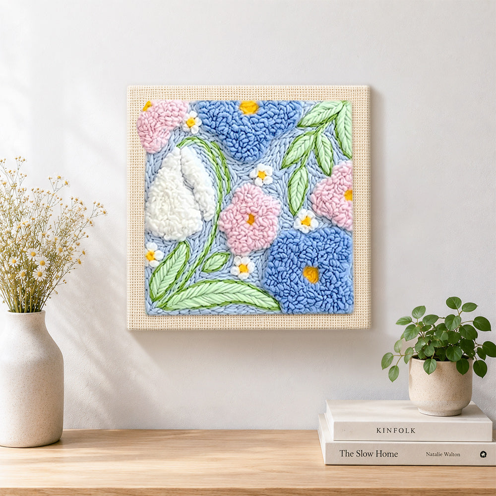 Finished pink, blue and white blossoms artwork displayed on a wall