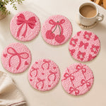 Pink bow and cherry punch needle coasters used for home decoration